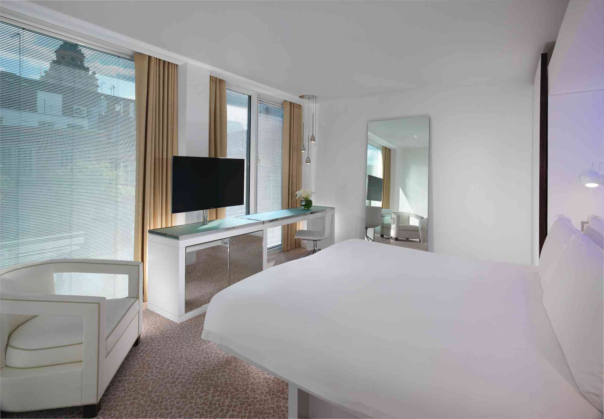 hotel loft junior suite with bed and large windows