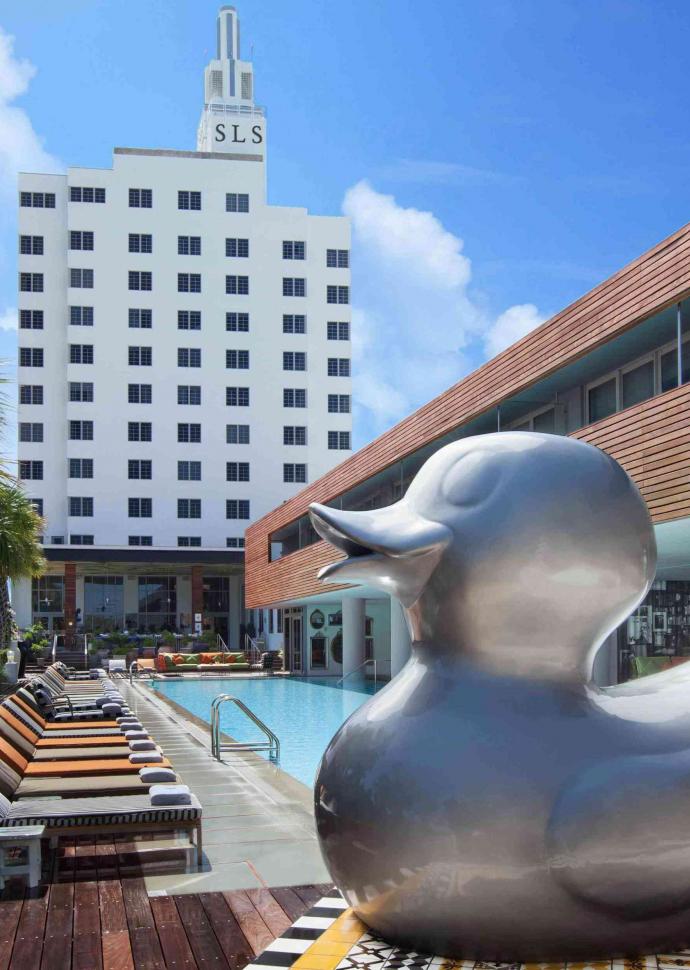 giant duck sculpture in front of pool