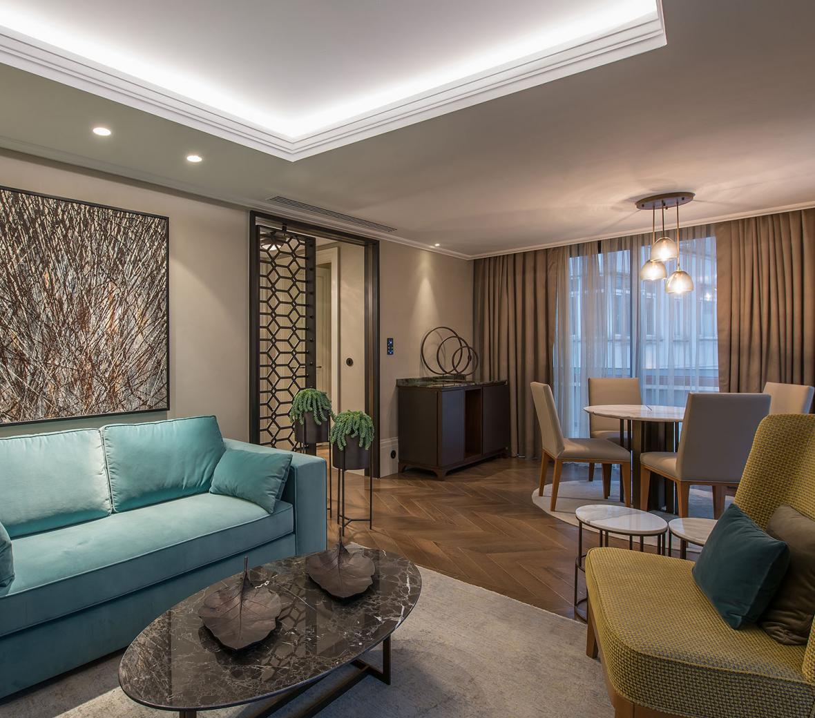 hotel terrace suite living area with couch and dining area