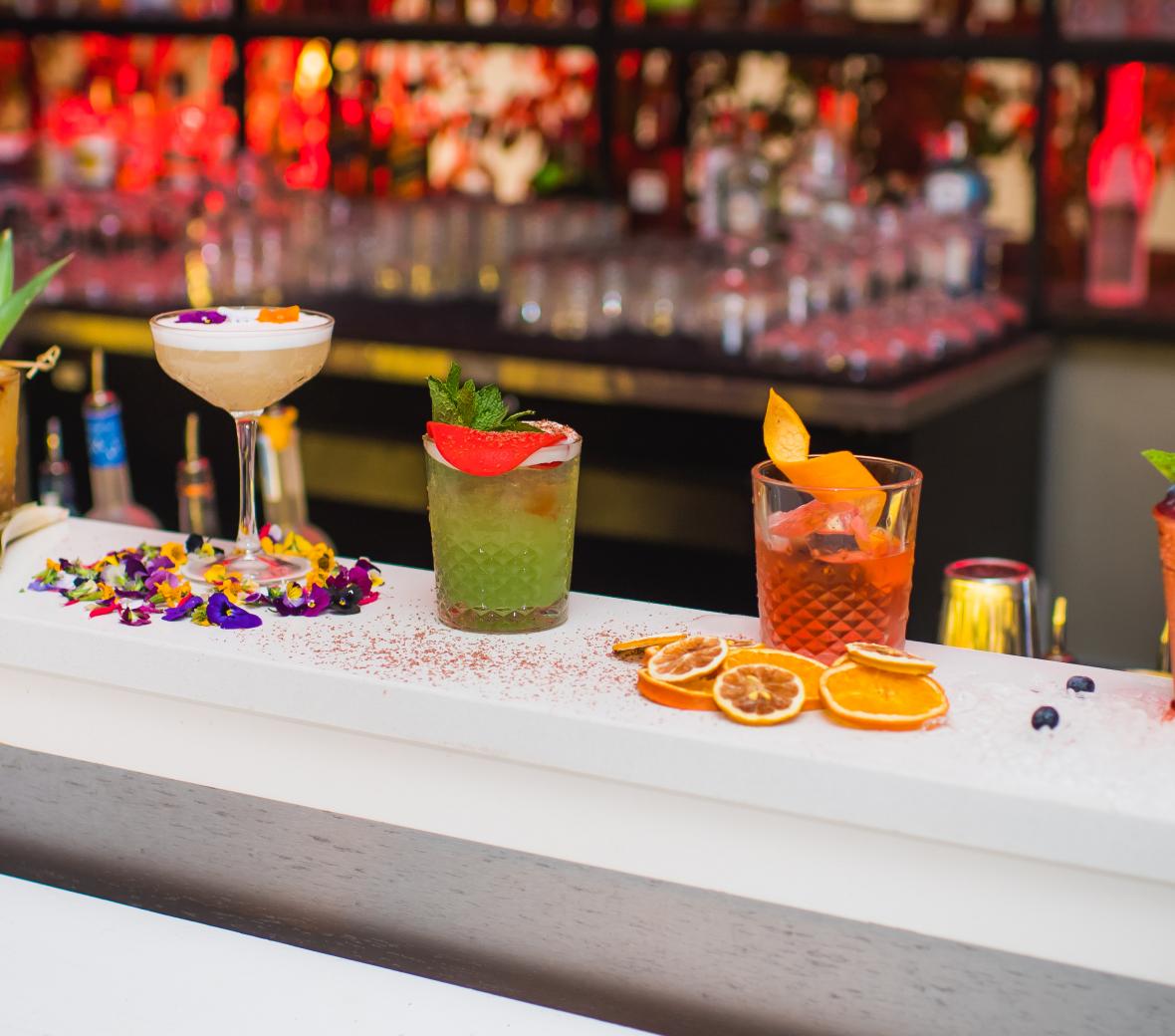 A row of exotic beverages on a bar top