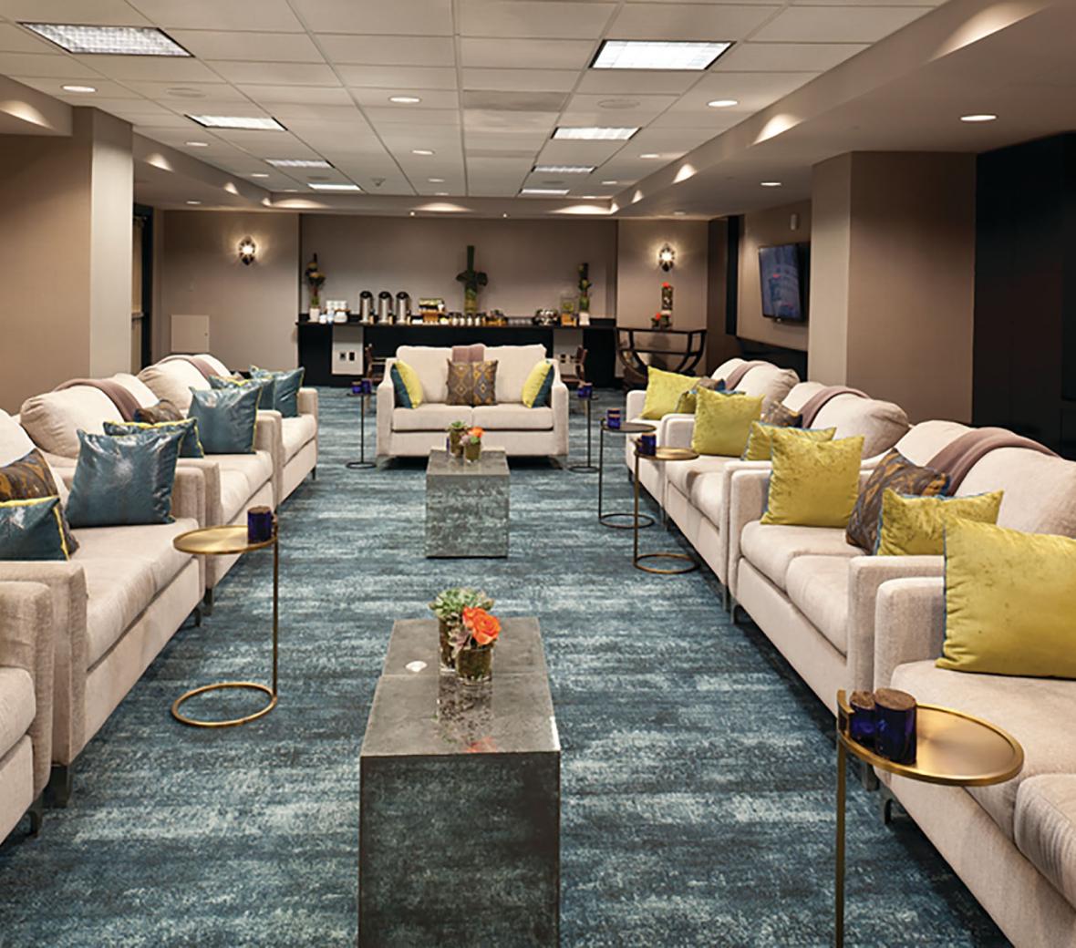 a meeting room set up with comfortable couches