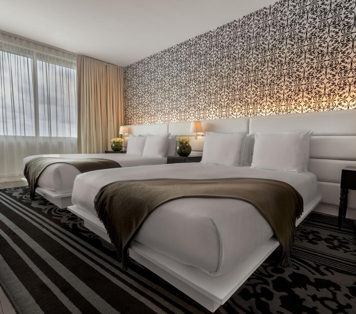 Two beds in a hotel room.