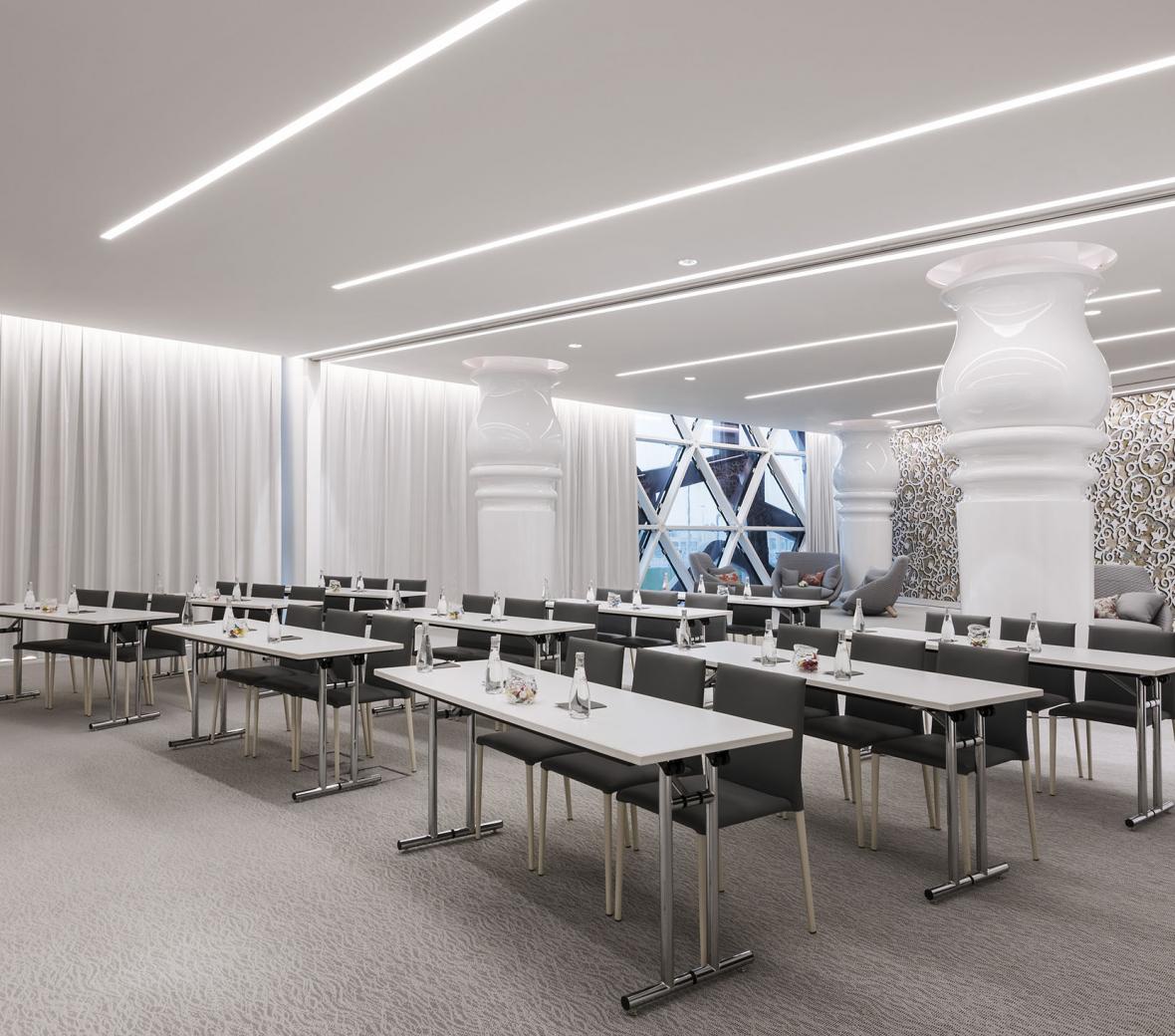 Meeting room set up with rows of tables