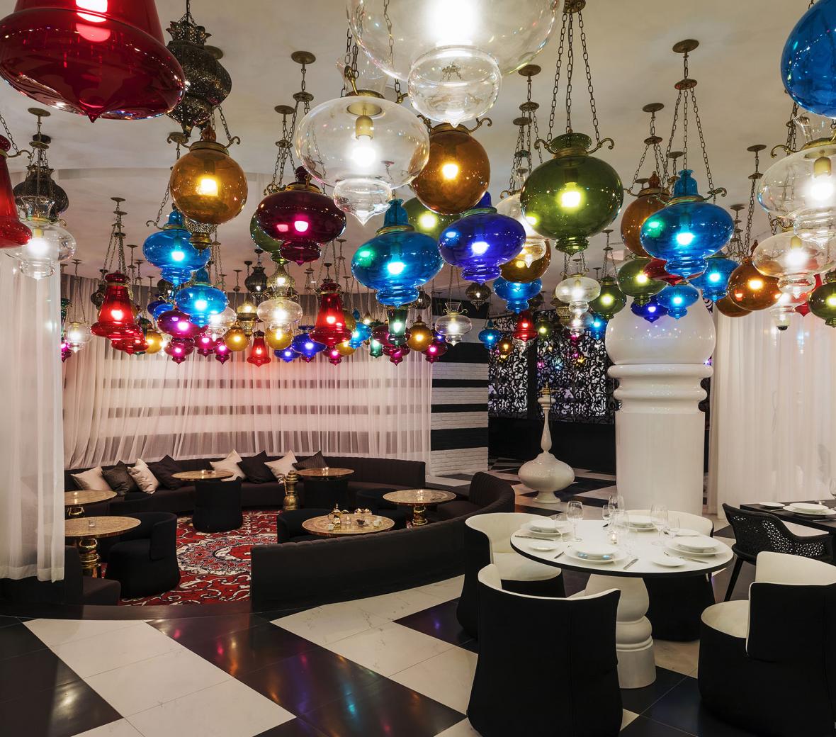 A black and white room with multi-colored ceiling lights