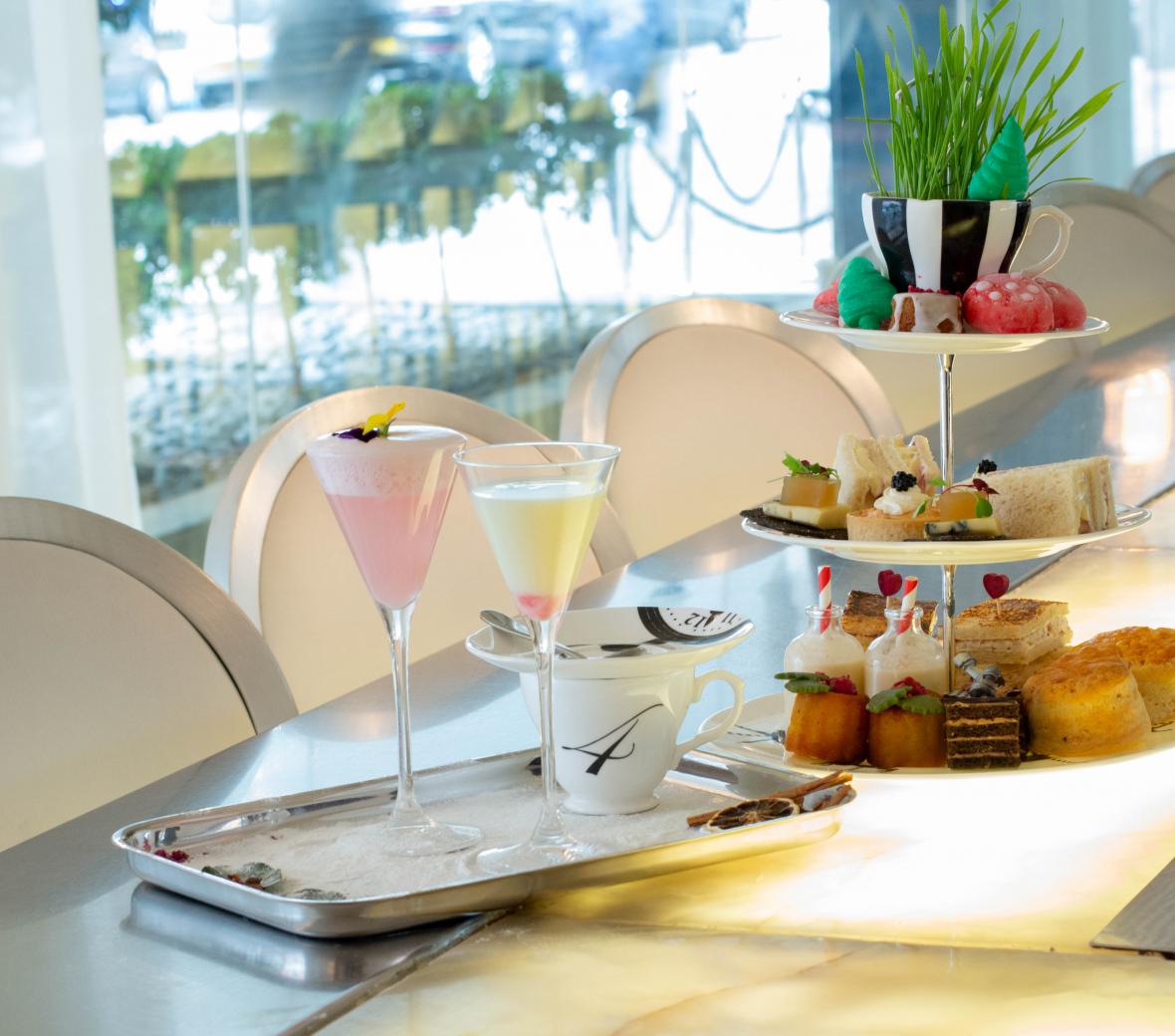 Photo of dessert and sandwich platter with cocktails.