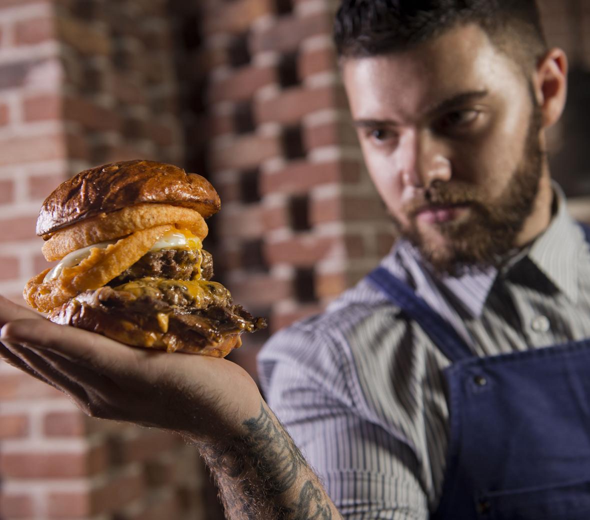 chef holding a hambuger