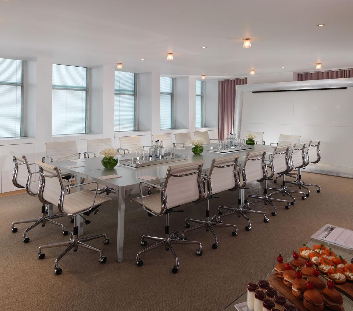 boardroom with white chairs 