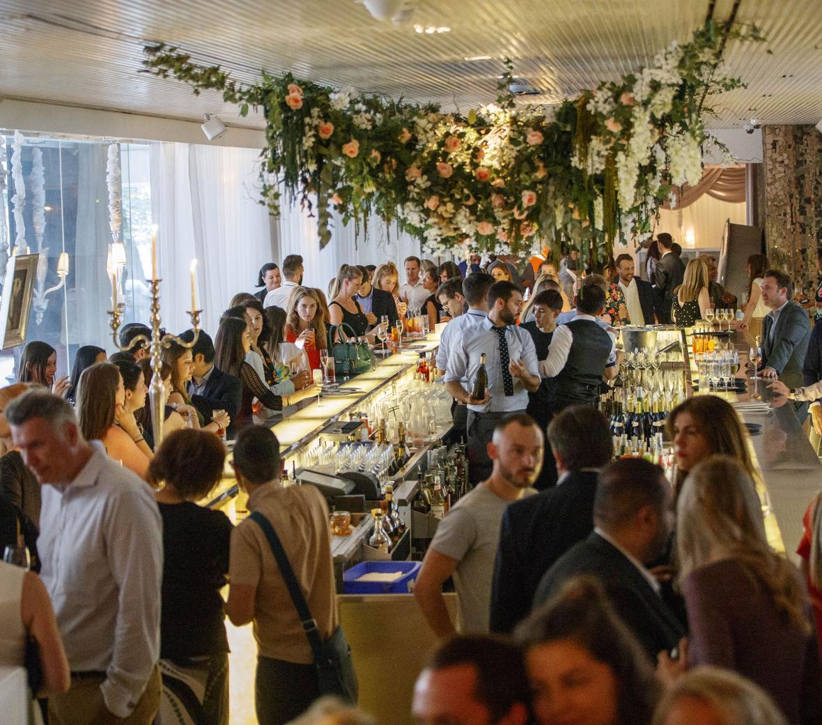 crowded reception area with hanging flowers