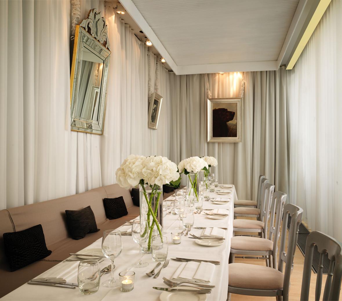terrace room with long dining table with white flowers