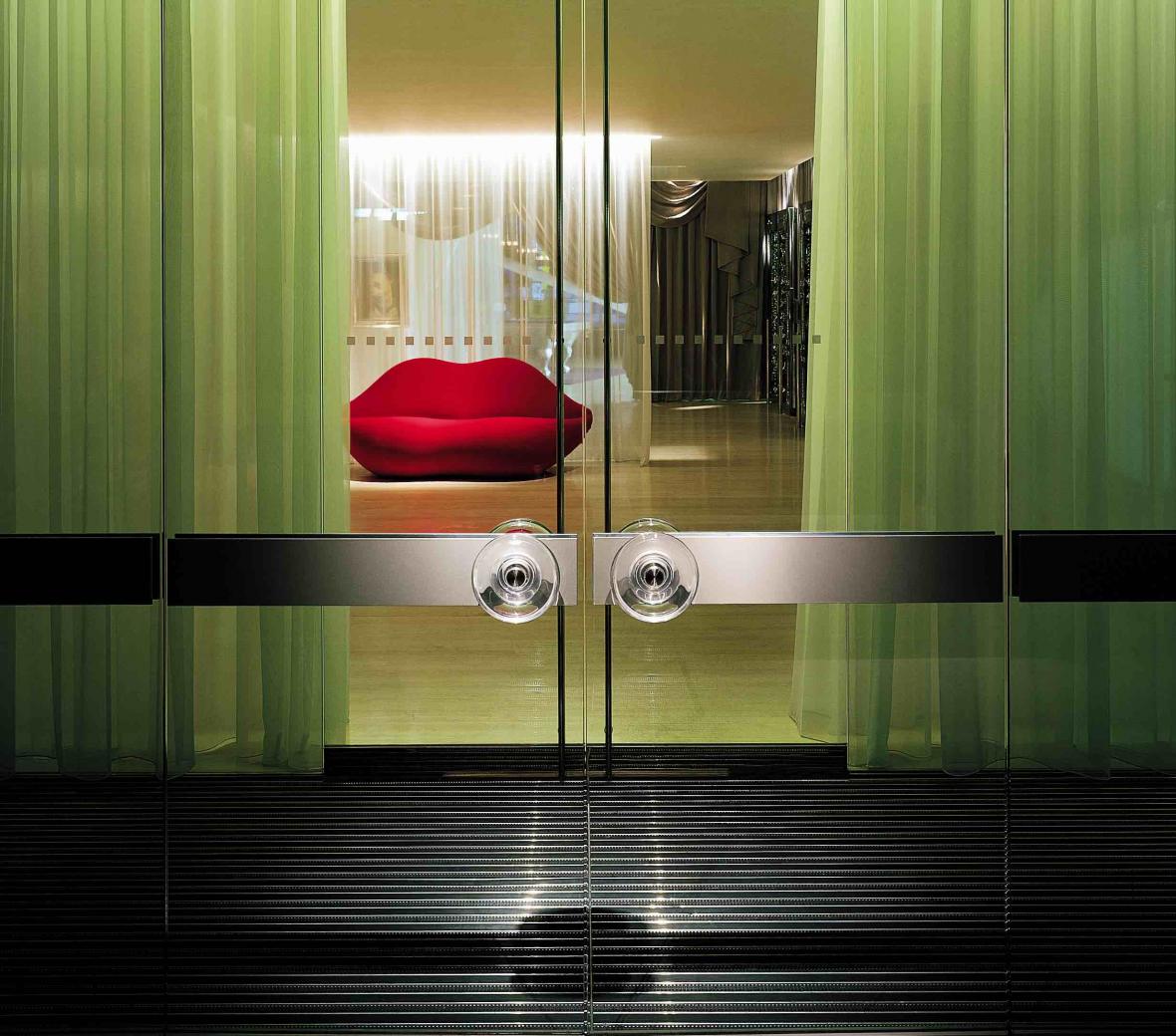 Entrance to hotel with red lip couch in background
