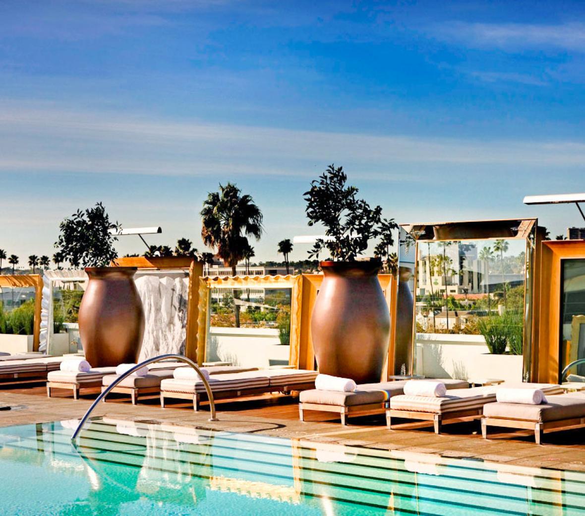a rooftop pool with cabanas