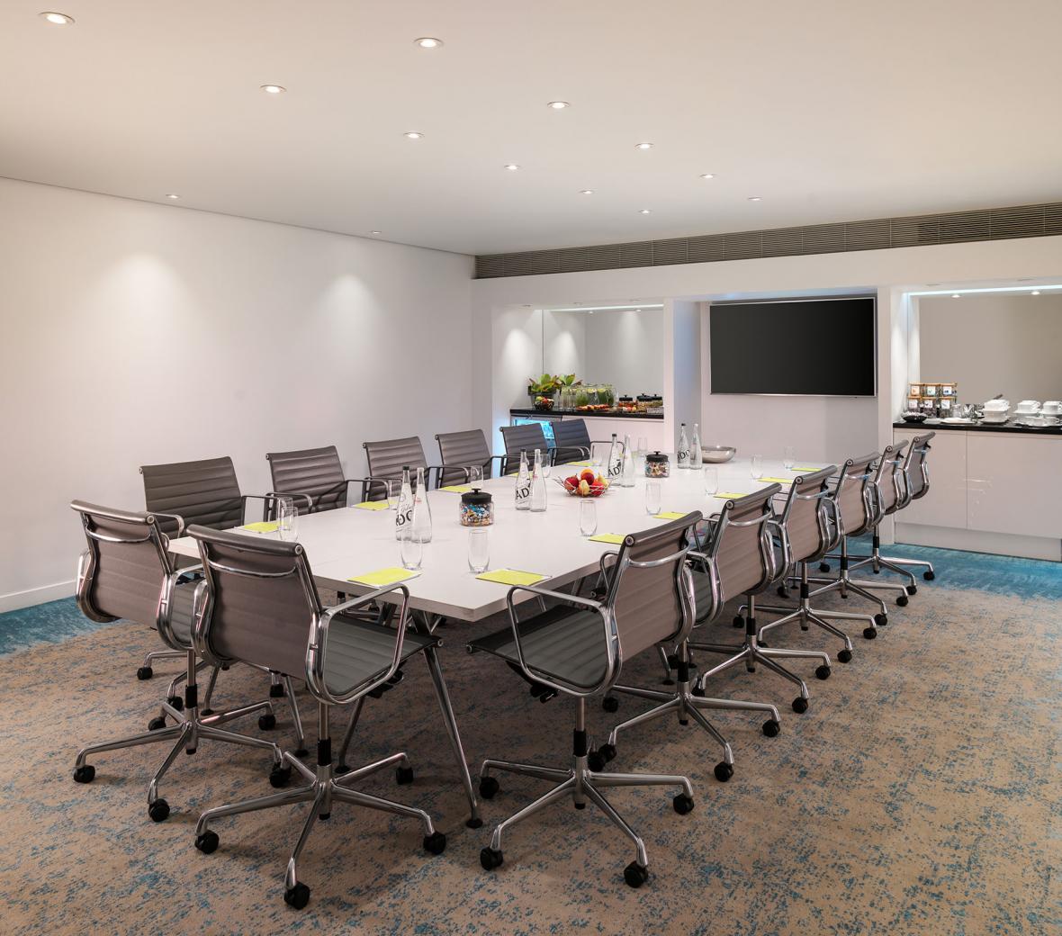 boardroom with large table and grey chairs