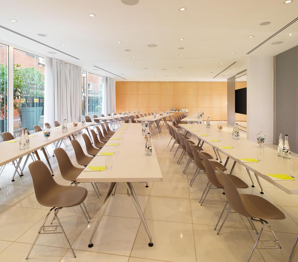 long rows of tables with chairs set up for presentation