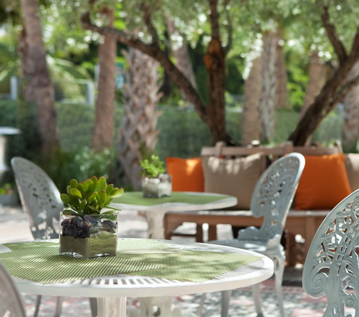 exterior garden area at Hyde Beach with patio tables