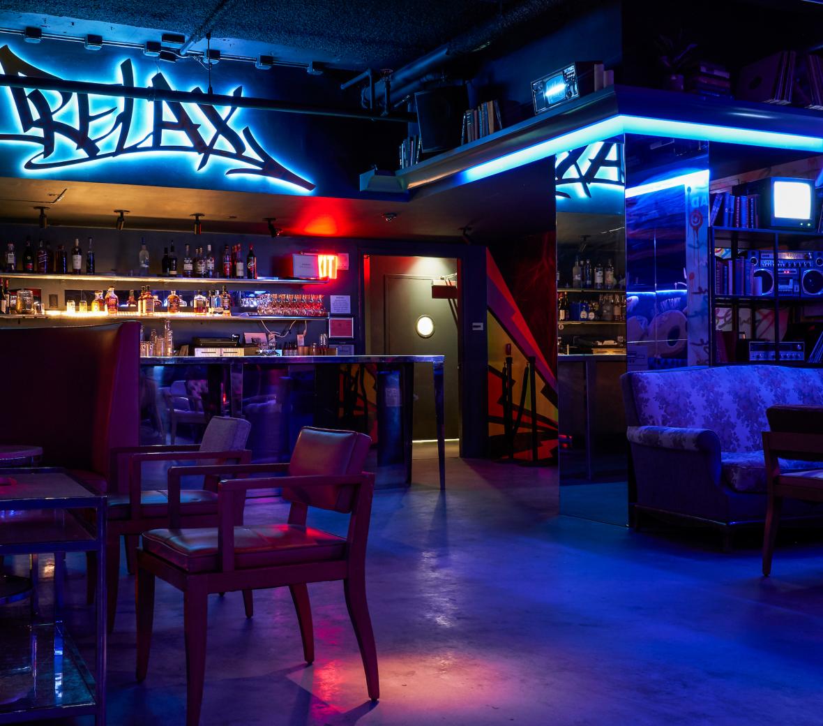 Boogie Room bar with tables and chairs and neon lights