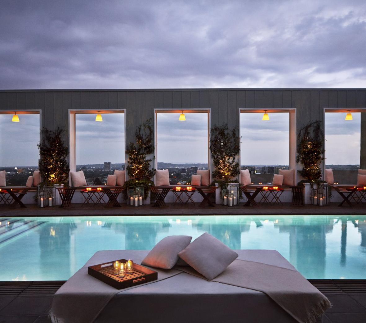 pool in the evening surrounded by tables and candles