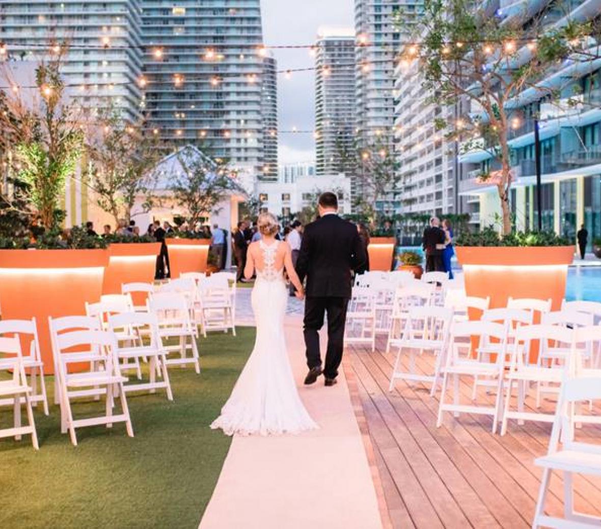 newlywed couple walks down aisle