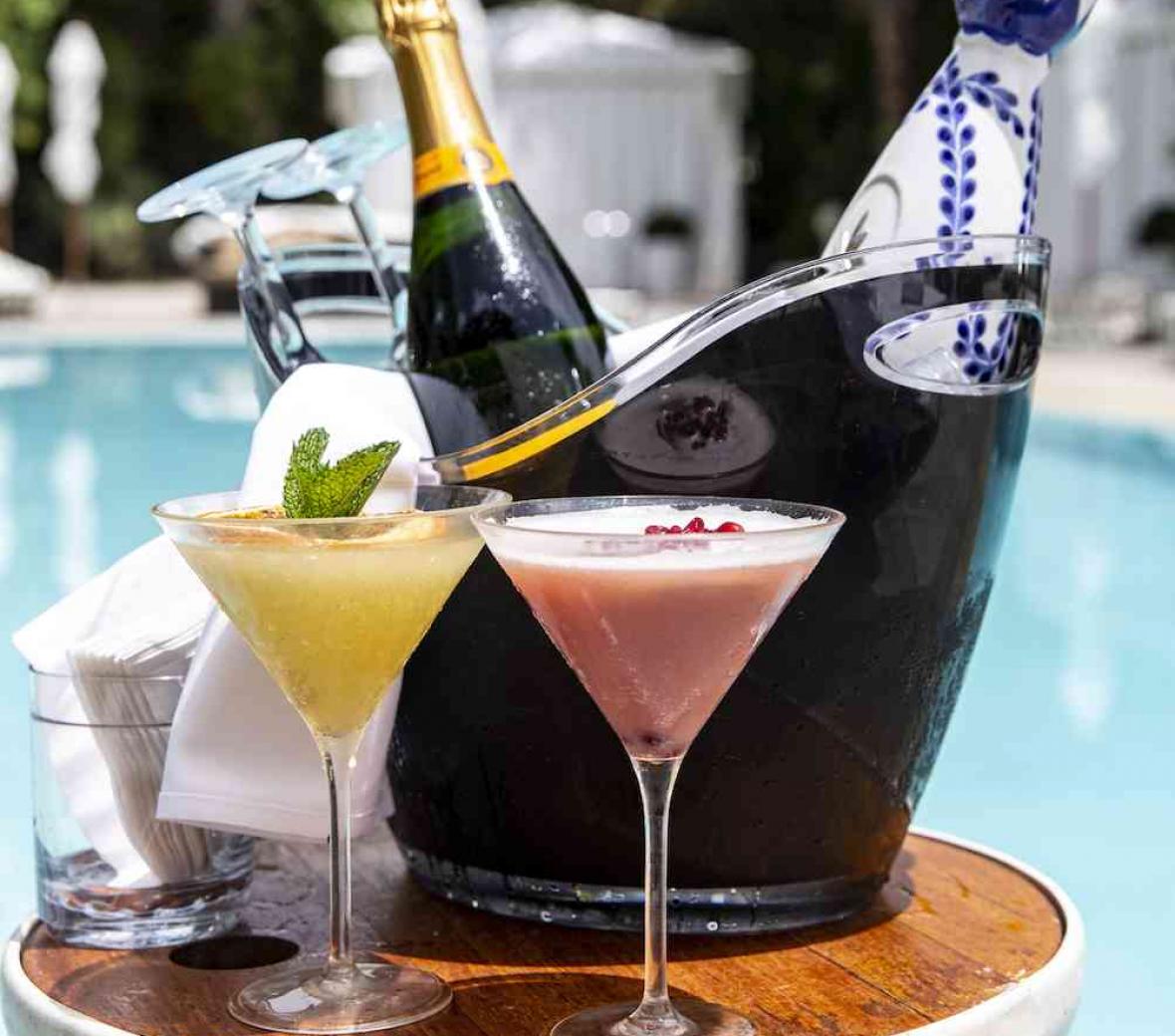 champage and cocktails in bucket near pool