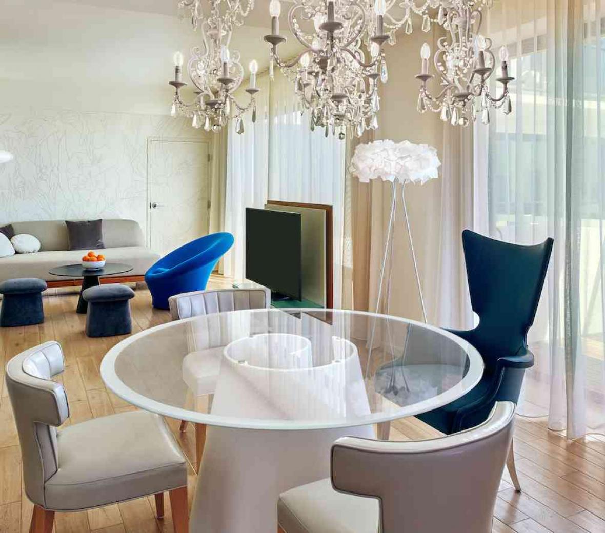 glass table under chandelier in living space