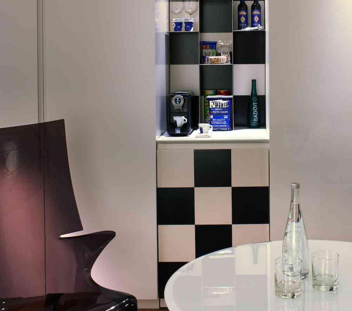 checkered minibar behind chair and table