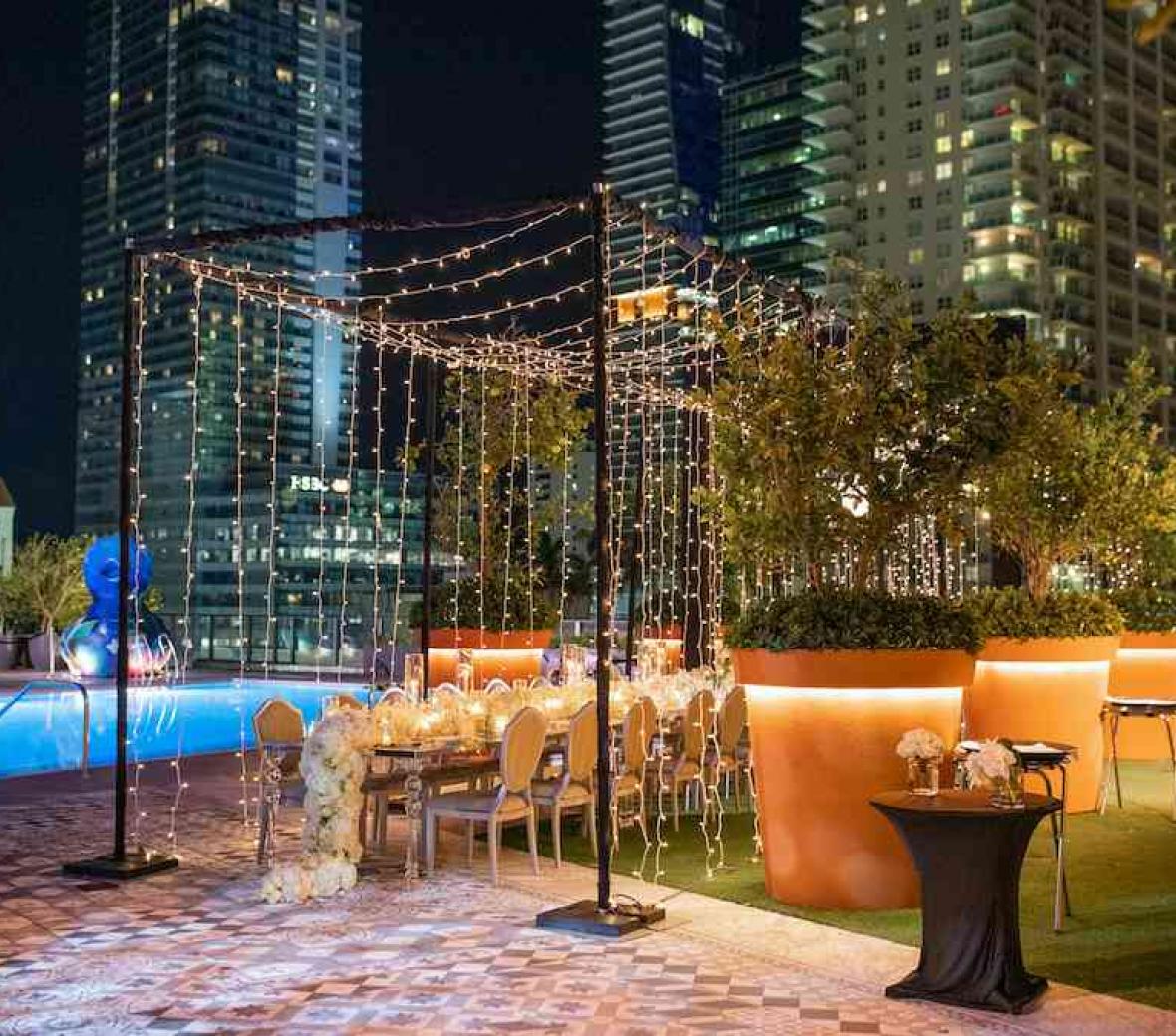 patio setting near pool and twinkling lights