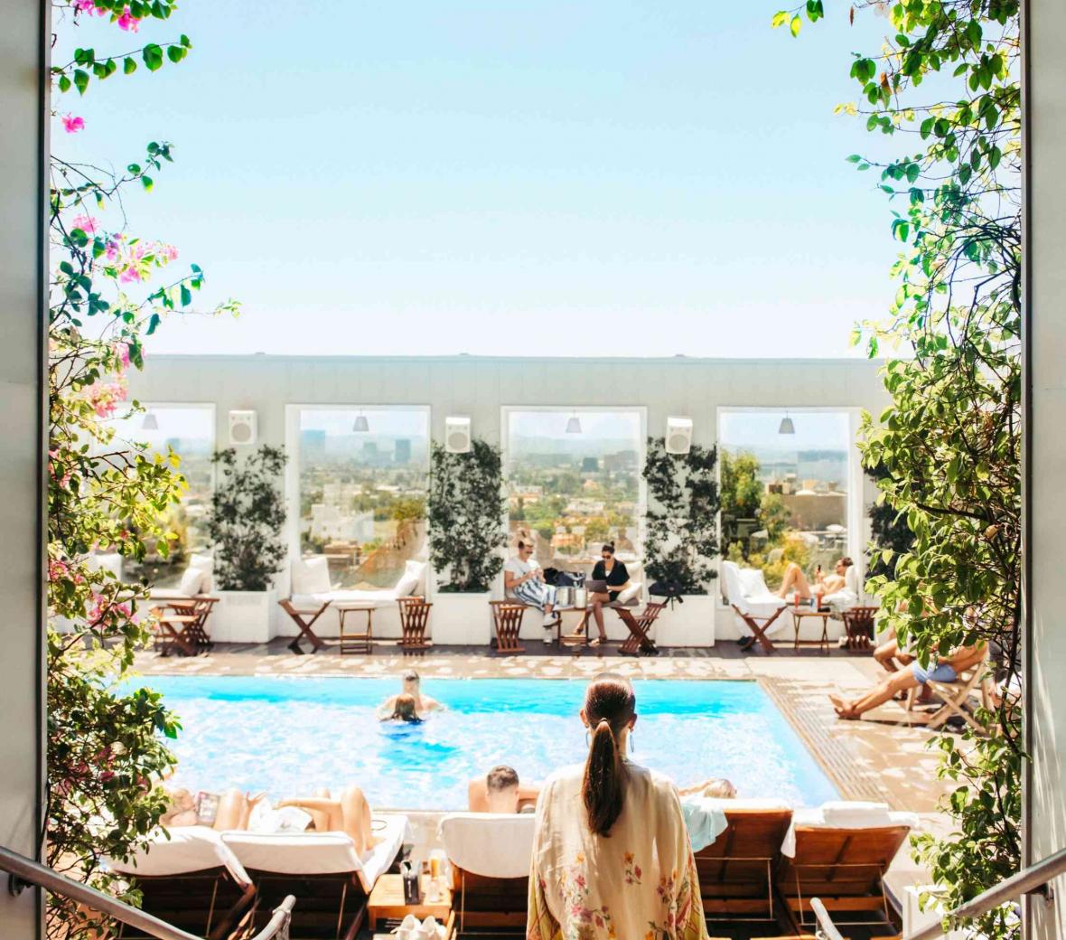 woman walking towards and outside pool