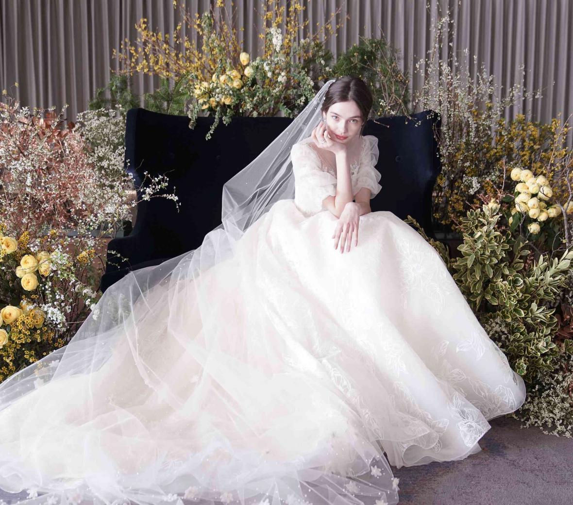 a bride sitting amongst flowers