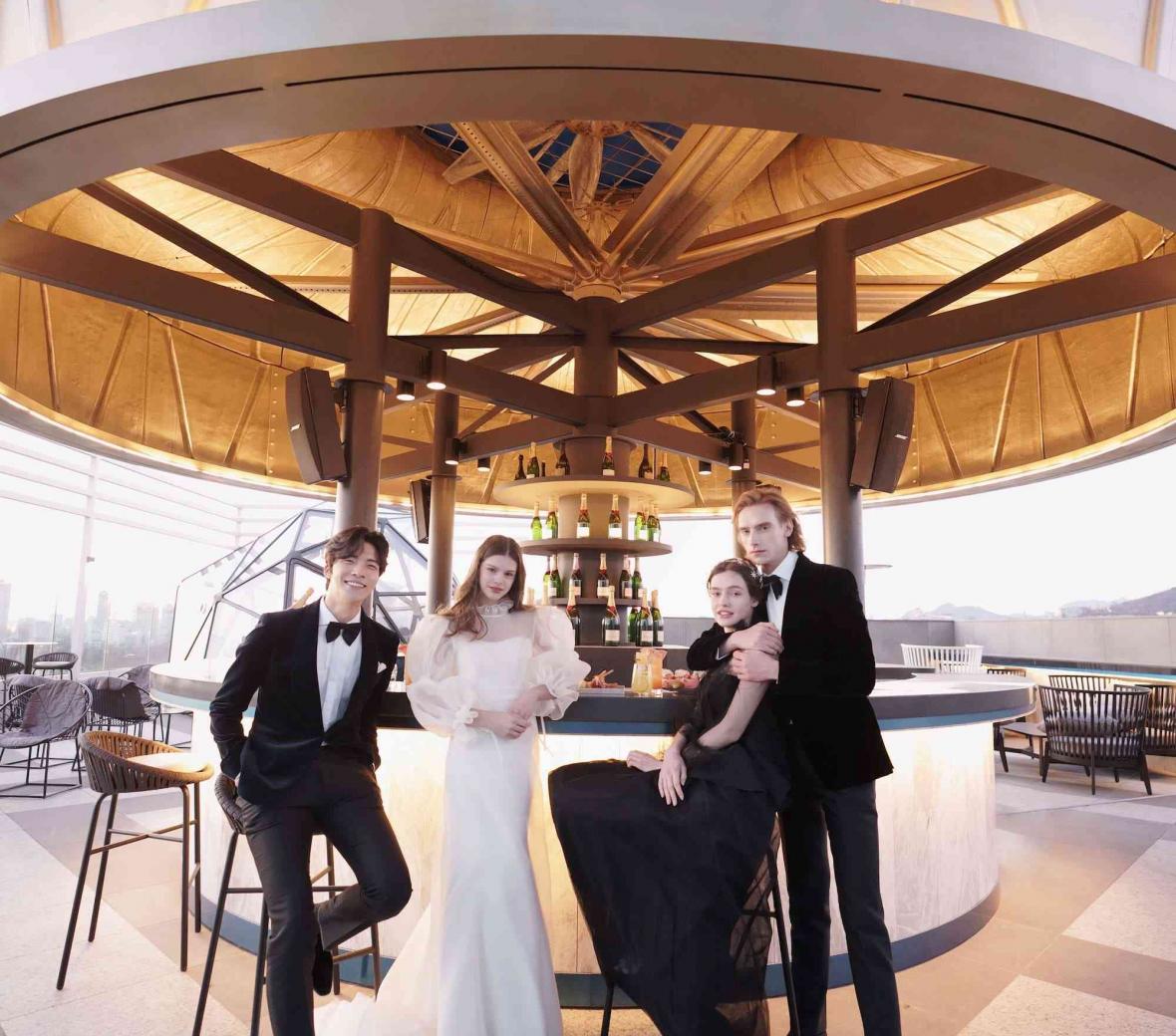 two couples on a rooftop patio