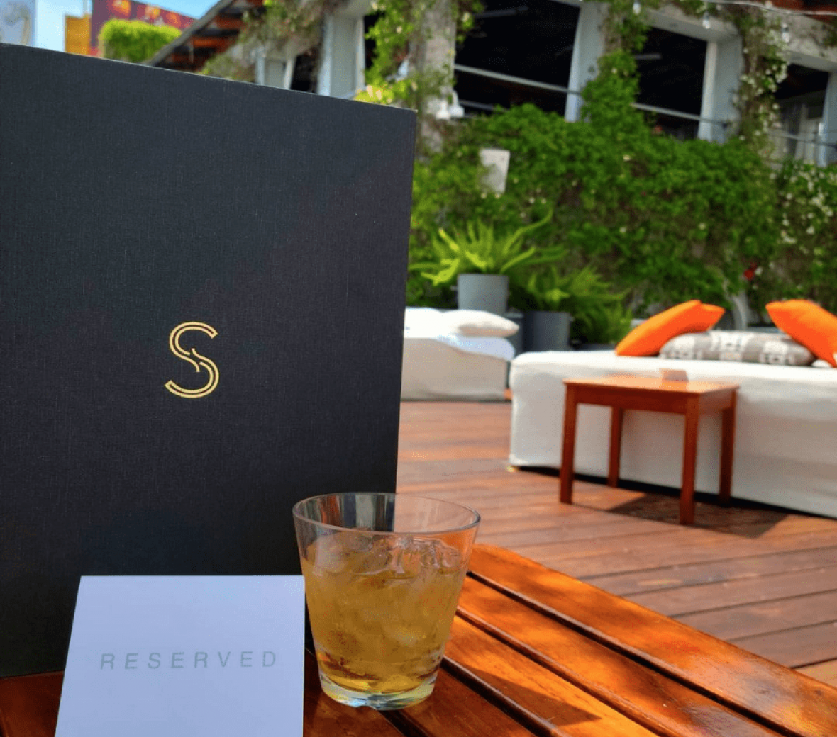 Close up of Skybar Menu with pool area in the background