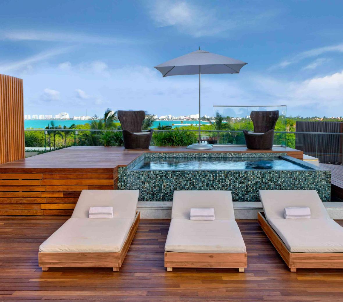 Patio with Jacuzzi overlooking a body of water