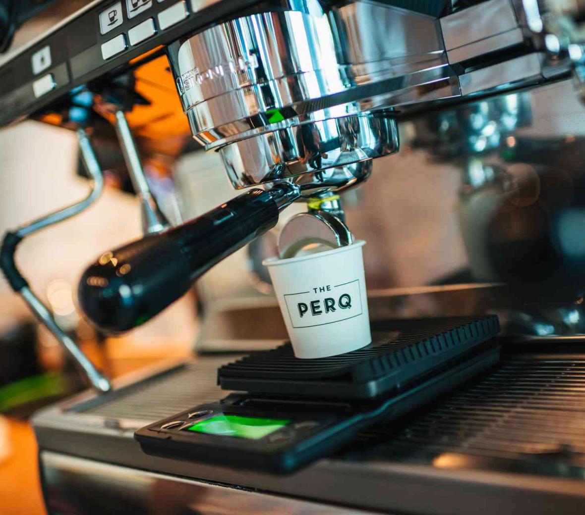 Espresso pouring into paper cup