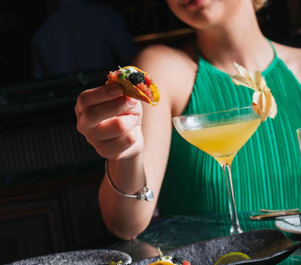 woman holding a tiny taco