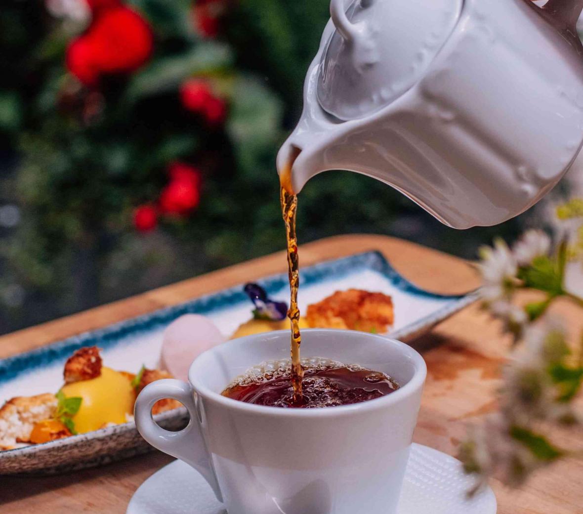 tea being poured into tea cup