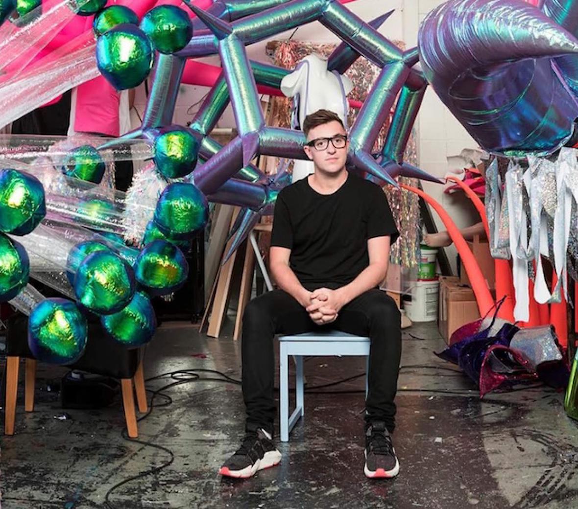 jack irving sitting in front of his work