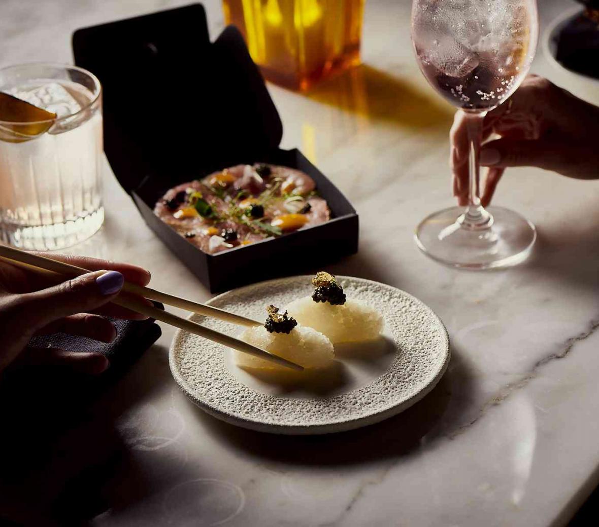 Person eating dumplings with chopsticks
