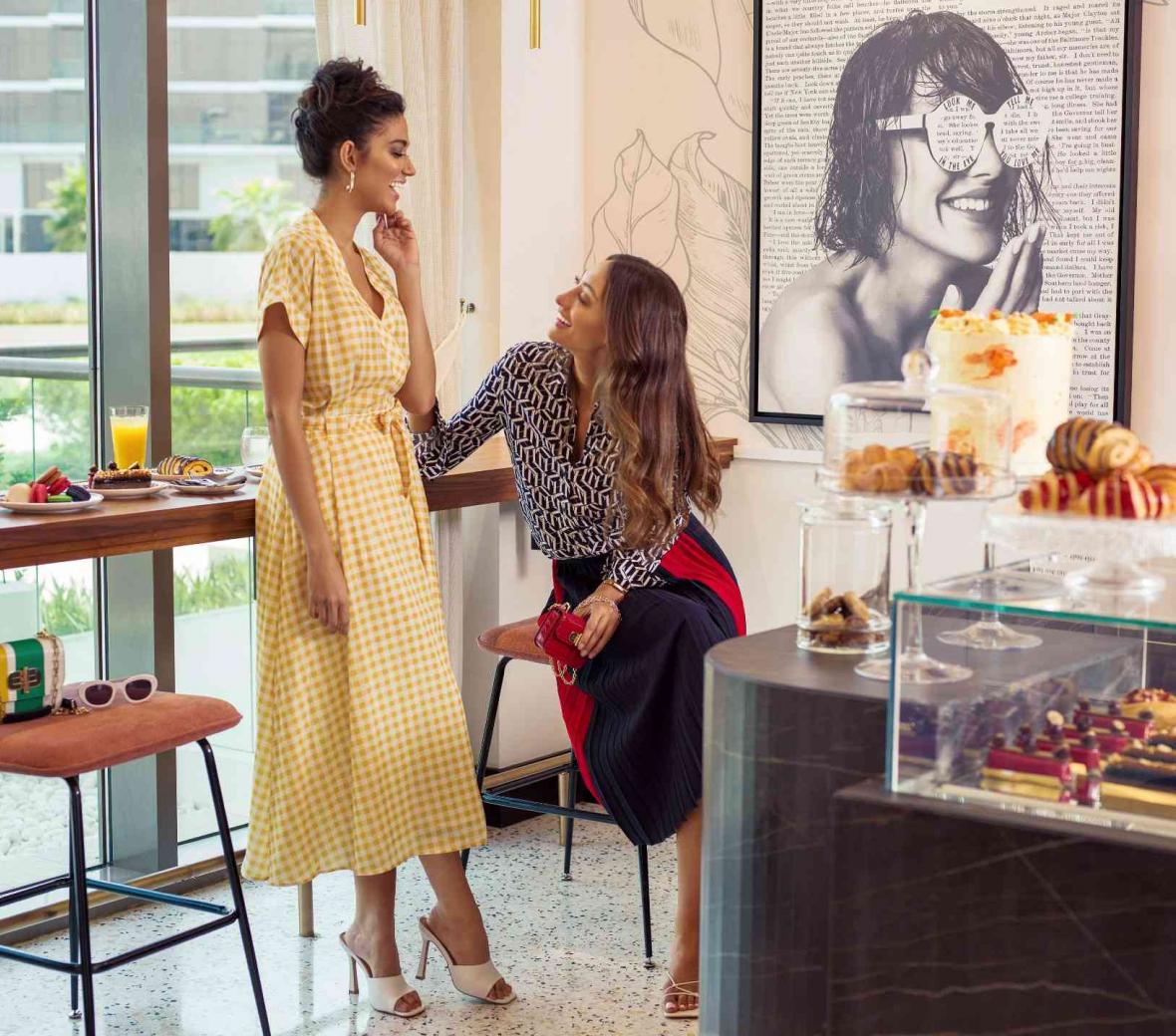 Two women enjoying a conversation at Th8 Palm Dubai EllaMia