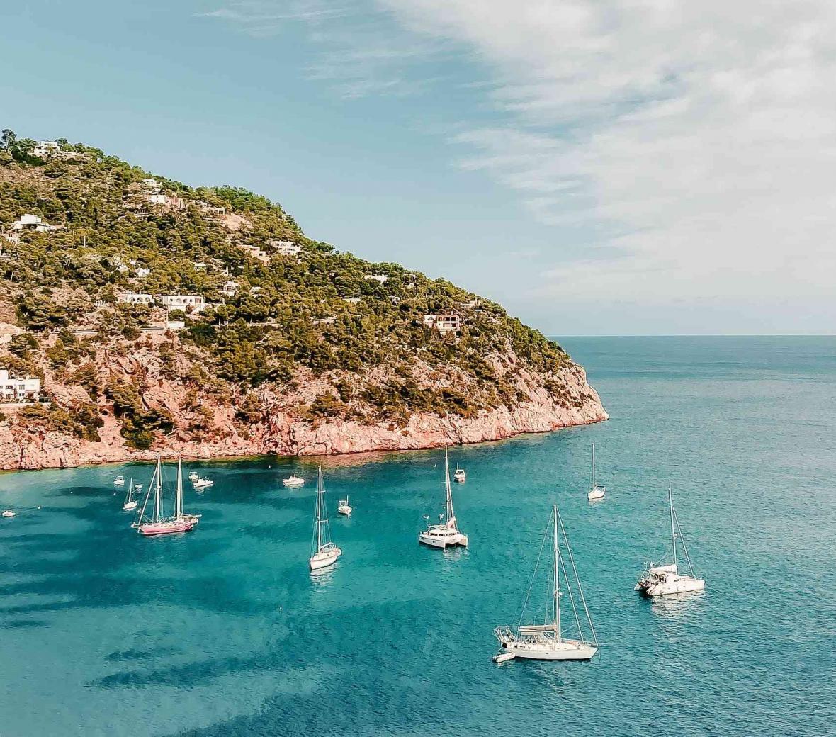 Ibiza shoreline with sailboats in the water