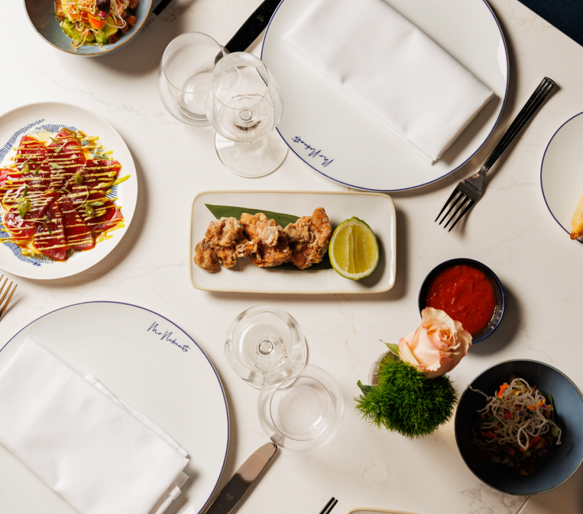 dishes on a table with food for Mr. Nakamoto restaurant
