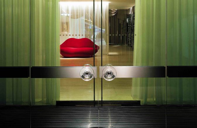 Entrance to hotel with red lip couch in background