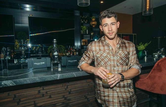 Nick Jonas at a bar