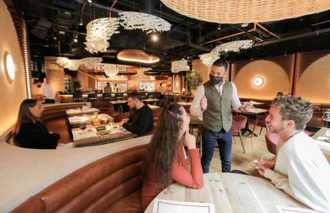 a server at a table in a restaurant