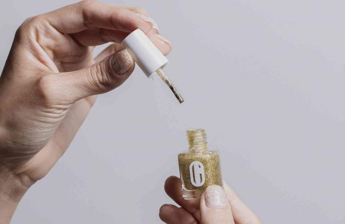 close-up of nails being painted