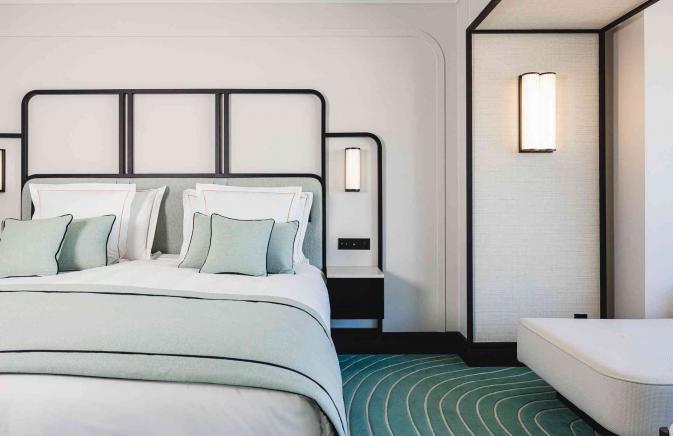 Modern room with light green and white linens. 