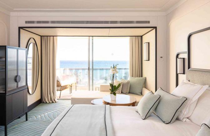 Large room with full wall windows overlooking the ocean