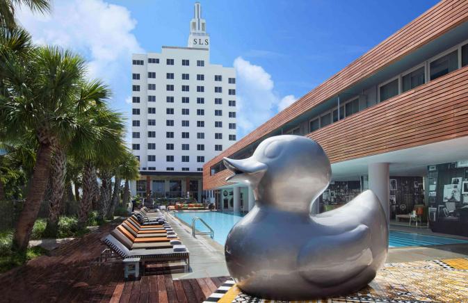 giant duck sculpture in front of pool 