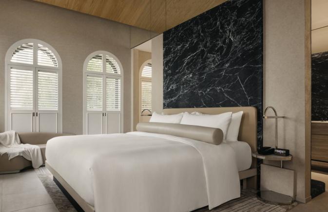 Mondrian Singapore Duxton hotel suite with king bed and large window.