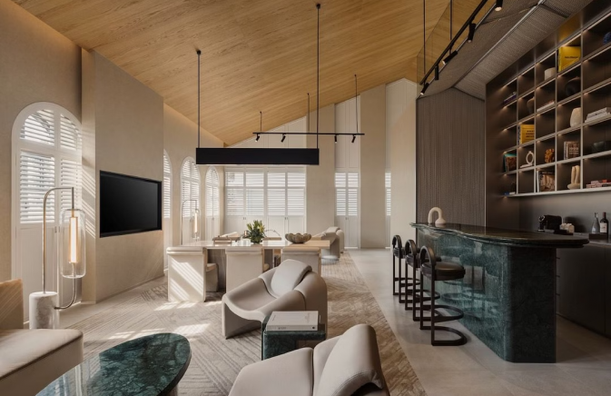 Mondrian Singapore's hotel living room featuring a bar area and a television.