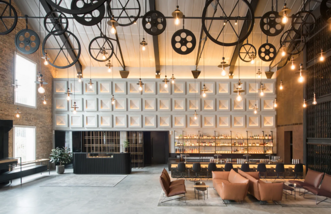 Mondrian Singapore lobby with a grand clock, exuding elegance and sophistication. The clock stands out as the focal point of the room.