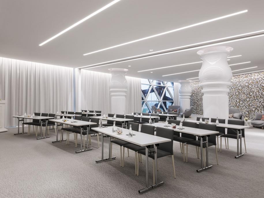 Meeting room set up with rows of tables