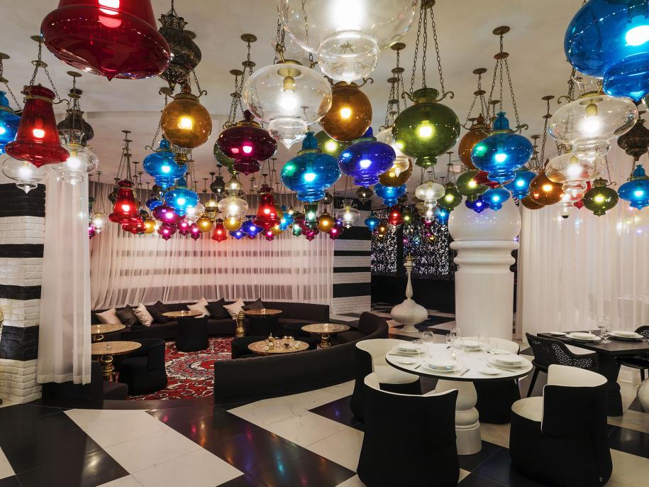 A black and white room with multi-colored ceiling lights